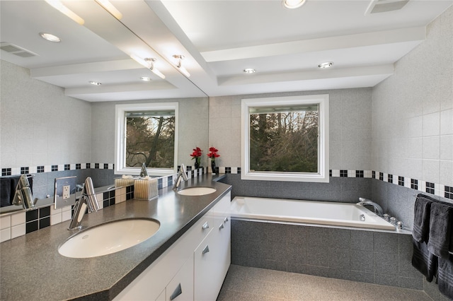 full bathroom featuring decorative backsplash, a sink, visible vents, and tile walls