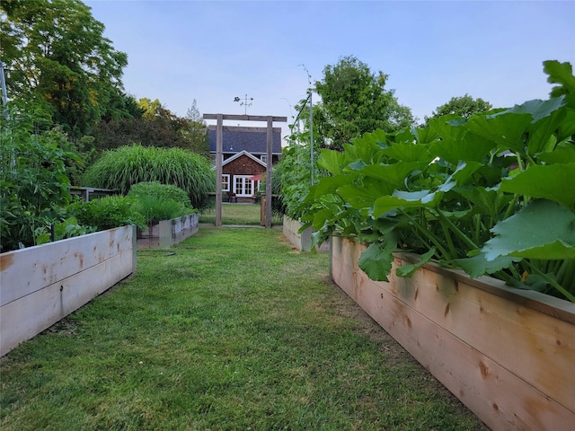 view of yard featuring a vegetable garden and fence