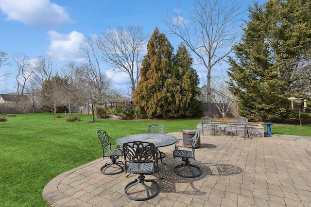 view of patio featuring outdoor dining area and fence