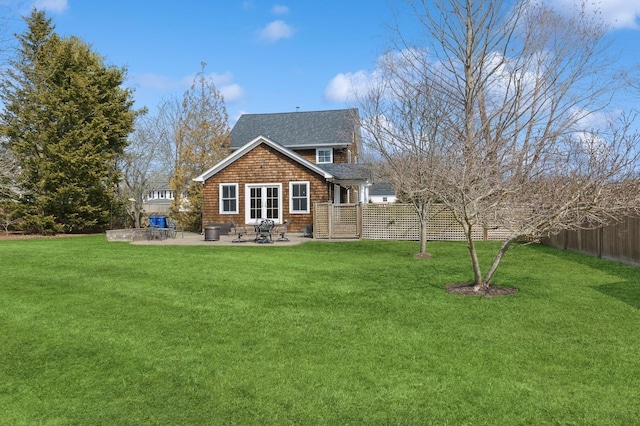 back of property with a patio, a lawn, and a fenced backyard