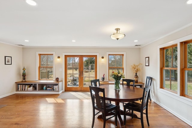 dining area with visible vents, baseboards, ornamental molding, french doors, and wood finished floors