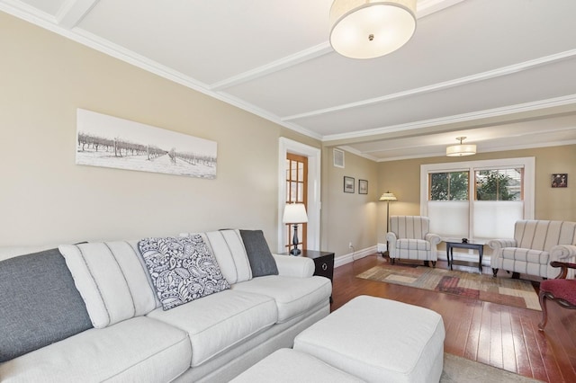 living area with visible vents, wood-type flooring, baseboards, and crown molding