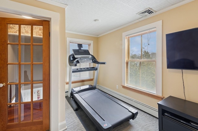 workout area featuring visible vents, a baseboard heating unit, and ornamental molding