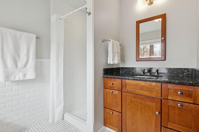 bathroom featuring a shower stall and vanity