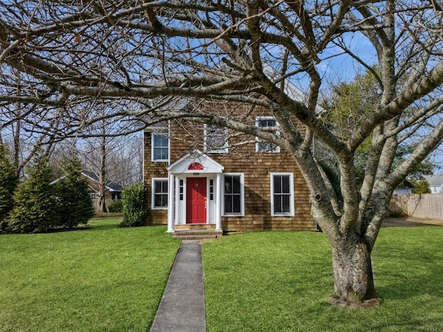 view of front of home featuring a front yard and fence