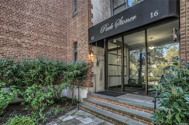 doorway to property featuring brick siding