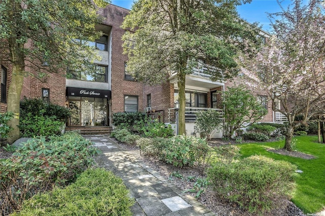 exterior space with a front lawn and brick siding