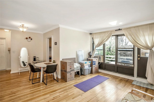 interior space with ornamental molding, hardwood / wood-style flooring, and baseboards