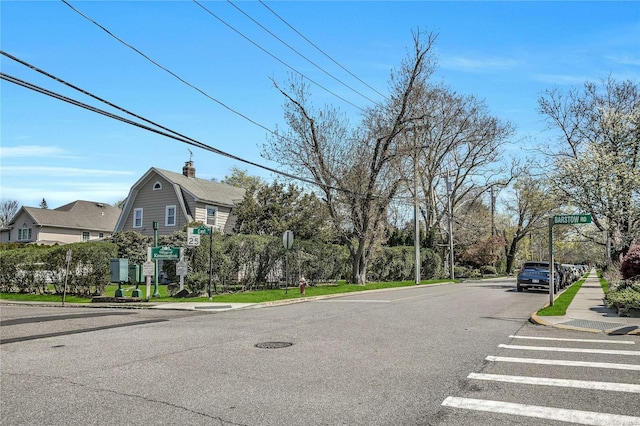 view of street with traffic signs, curbs, and sidewalks