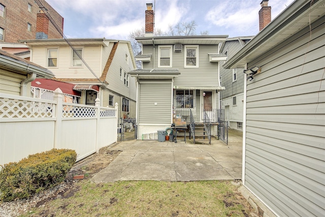 rear view of house featuring fence