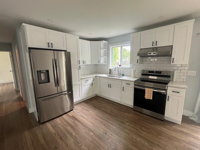 kitchen with a sink, dark wood-type flooring, under cabinet range hood, appliances with stainless steel finishes, and open shelves