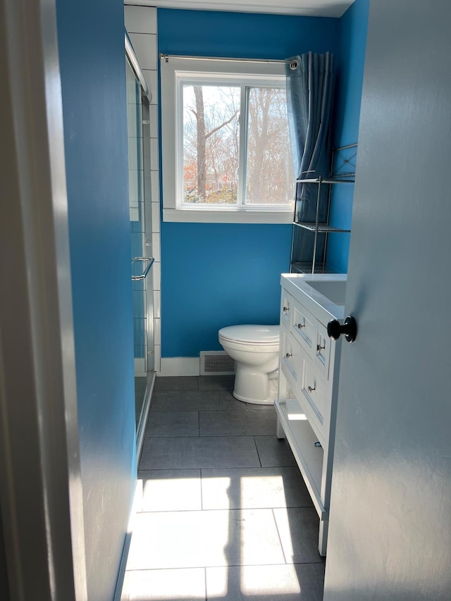 full bathroom with visible vents, toilet, a stall shower, tile patterned flooring, and baseboards