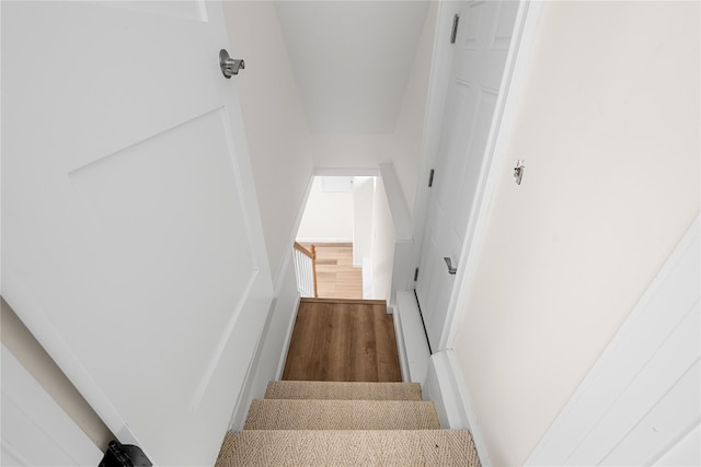 staircase with wood finished floors