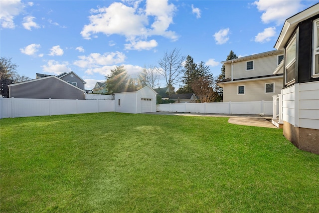 view of yard with an outbuilding and a fenced backyard