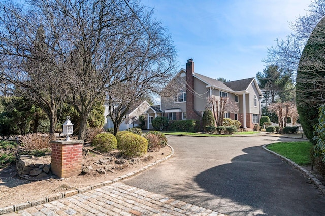 view of home's exterior with brick siding and a chimney