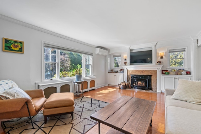 living room with an AC wall unit, a fireplace with flush hearth, and ornamental molding