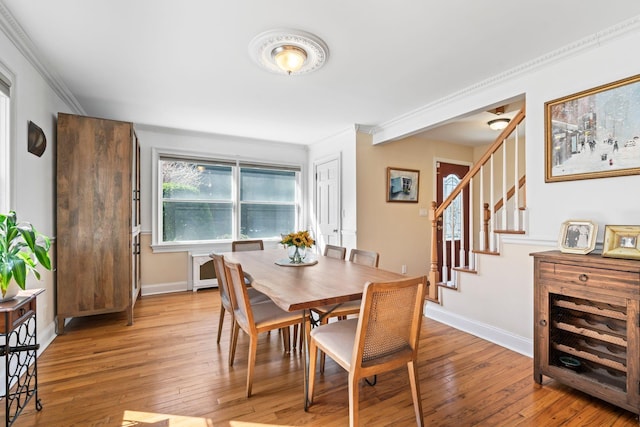 dining room featuring stairway, baseboards, and light wood-style floors