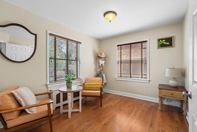 living area with baseboards and light wood-style flooring