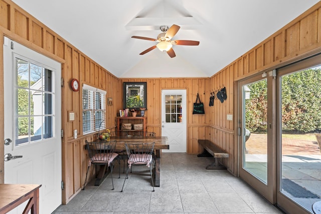 sunroom / solarium with ceiling fan and vaulted ceiling