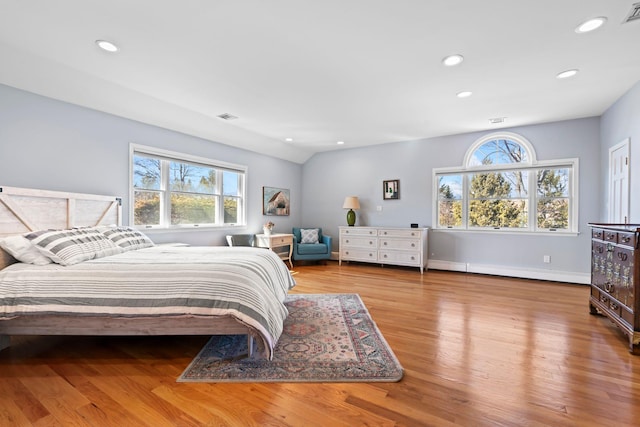 bedroom featuring recessed lighting, visible vents, wood finished floors, and a baseboard radiator