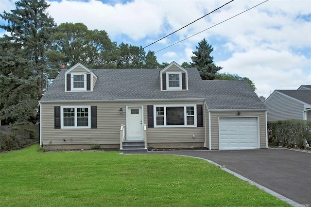 cape cod house with a shingled roof, aphalt driveway, entry steps, a front yard, and an attached garage