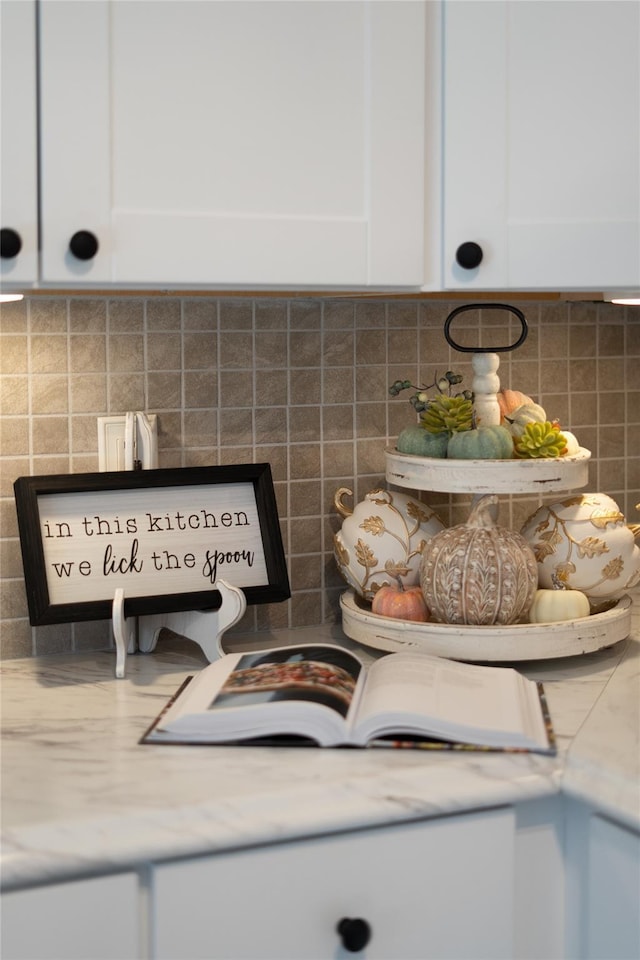 details featuring white cabinetry and decorative backsplash