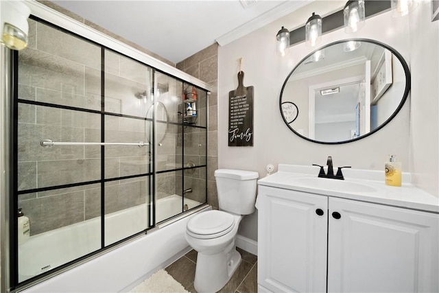 full bath with bath / shower combo with glass door, toilet, ornamental molding, vanity, and tile patterned floors