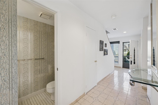 corridor with light tile patterned floors, visible vents, baseboards, and recessed lighting