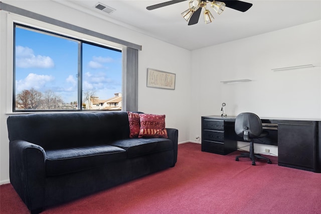 office space featuring visible vents, ceiling fan, and carpet