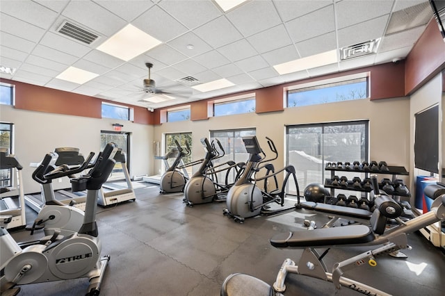 workout area with visible vents, a paneled ceiling, and ceiling fan