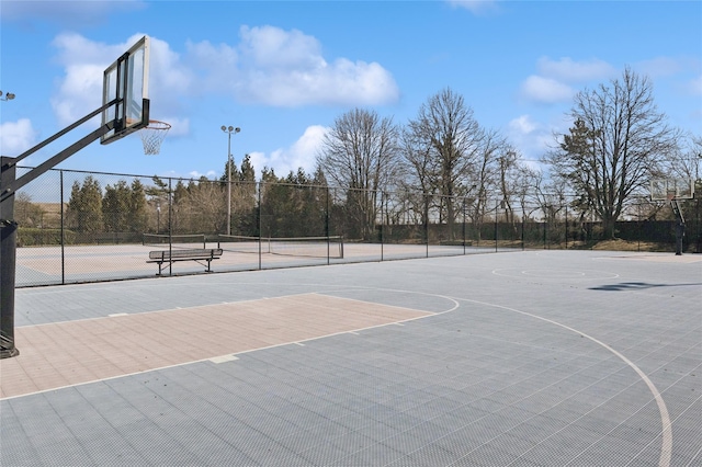 view of basketball court with community basketball court and fence