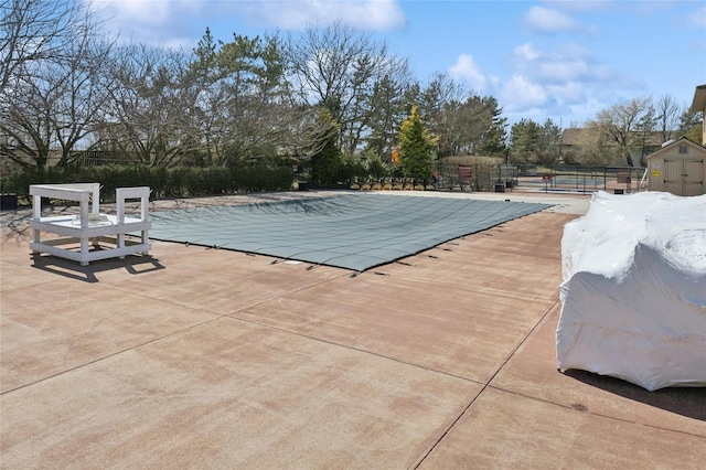 community pool featuring a patio and fence