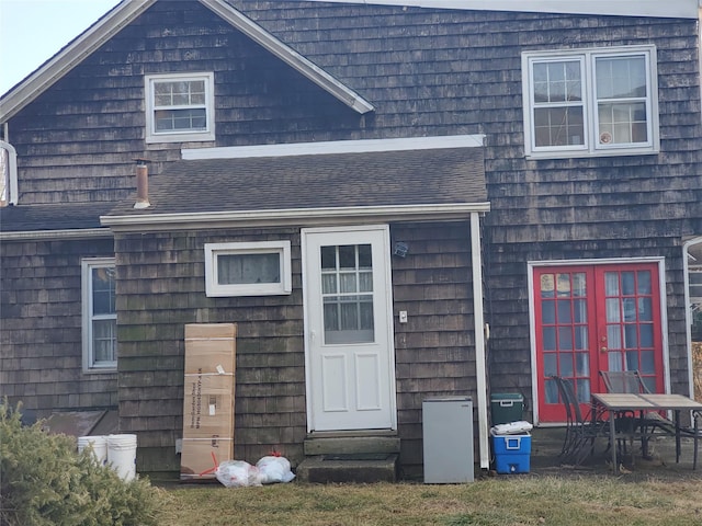 exterior space with roof with shingles