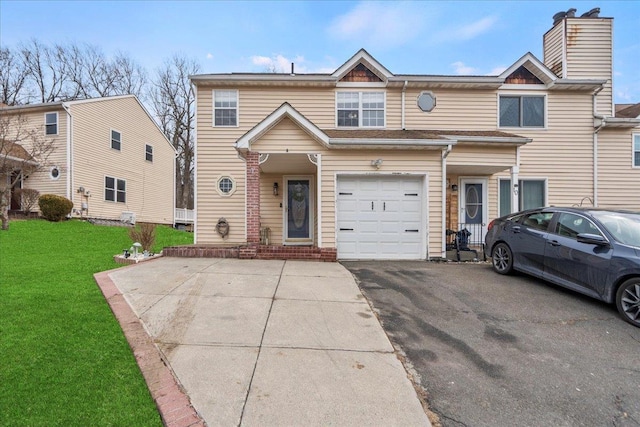 townhome / multi-family property with driveway and a front lawn