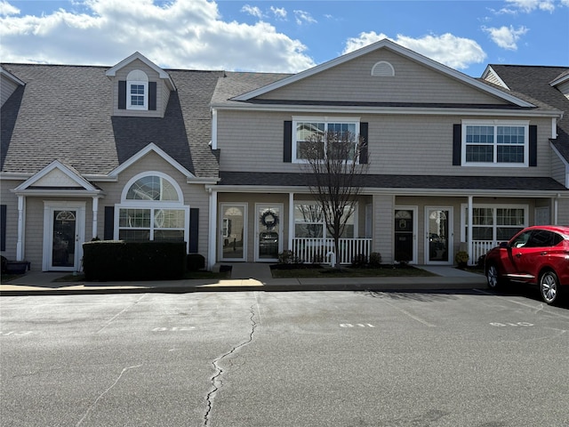 view of front facade featuring roof with shingles