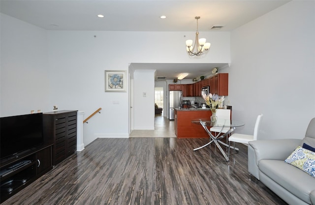 living room featuring recessed lighting, a notable chandelier, visible vents, baseboards, and dark wood finished floors