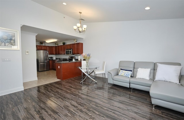 living room with a chandelier, recessed lighting, wood finished floors, and baseboards