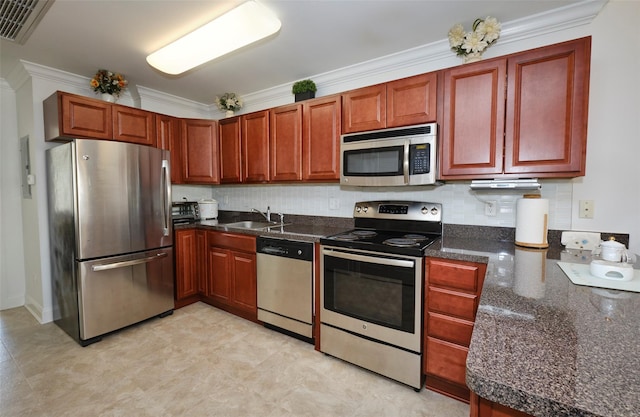 kitchen with dark countertops, tasteful backsplash, visible vents, and stainless steel appliances