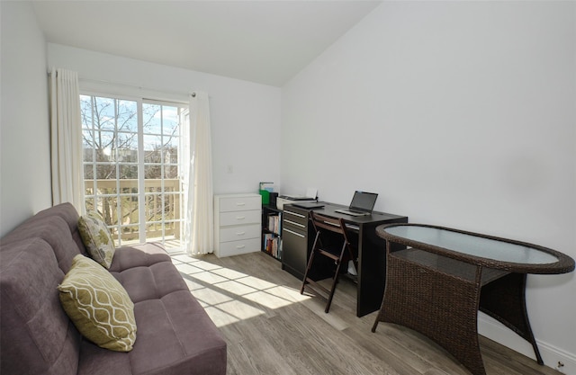 office area with lofted ceiling, light wood-style flooring, and baseboards