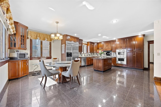 dining area with an inviting chandelier, granite finish floor, baseboards, and recessed lighting