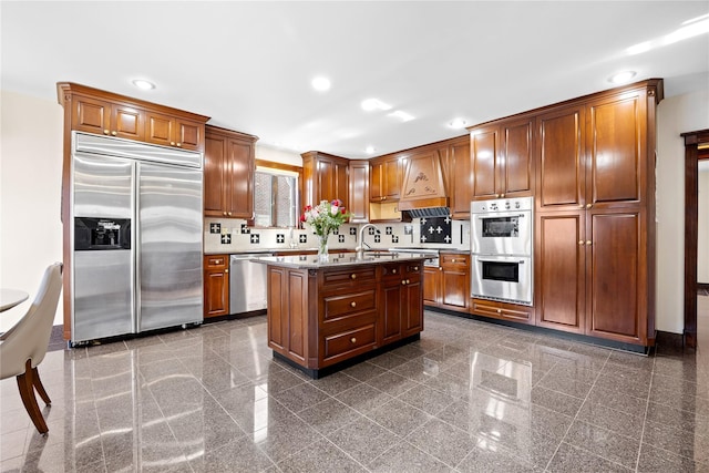 kitchen with custom range hood, stainless steel appliances, granite finish floor, and recessed lighting