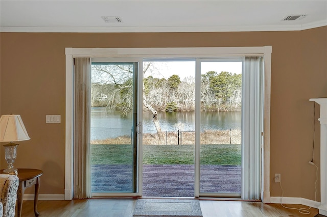 doorway to outside with visible vents, a water view, and crown molding