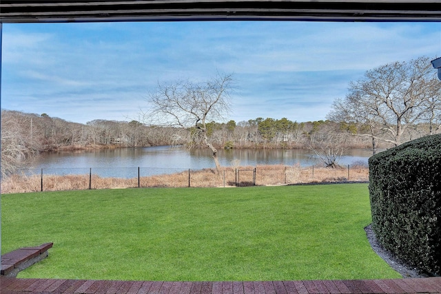 view of yard with fence and a water view