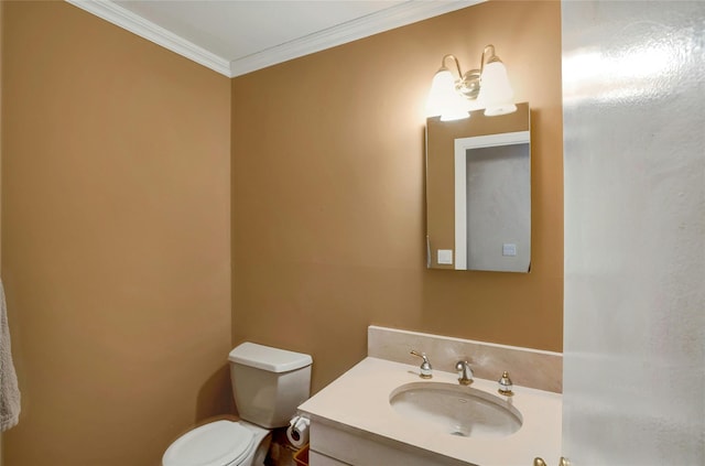 bathroom with vanity, crown molding, and toilet