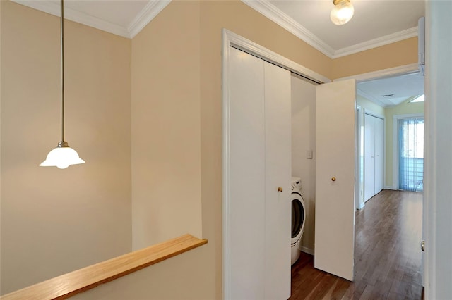 hallway featuring dark wood finished floors, washer / dryer, and ornamental molding