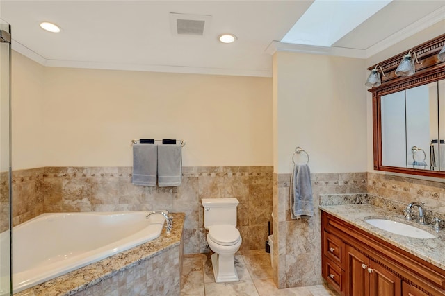 full bathroom featuring visible vents, toilet, a garden tub, ornamental molding, and vanity