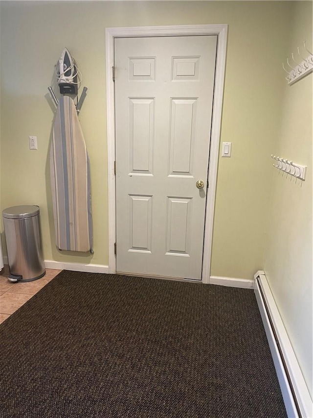 carpeted spare room with baseboards and baseboard heating