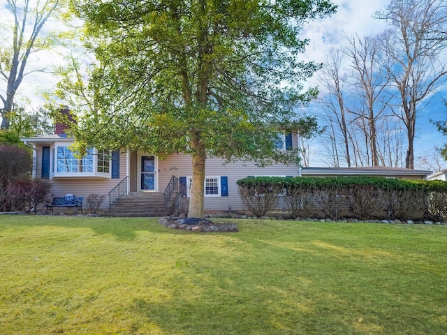 view of front of home with a front yard and a chimney