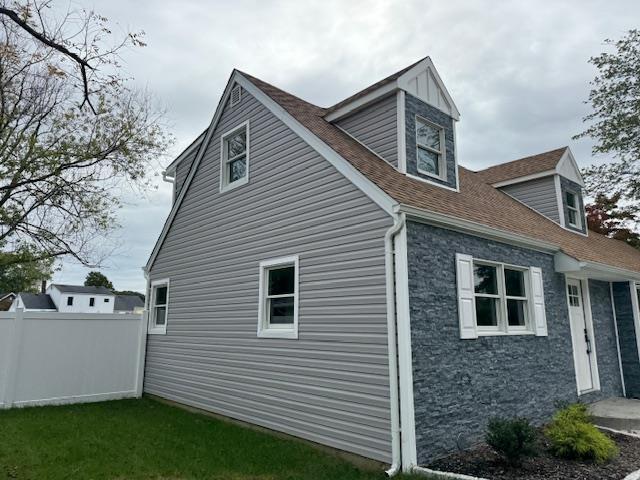 view of property exterior with fence