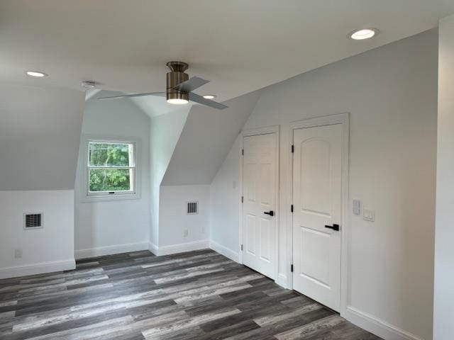 bonus room with lofted ceiling, visible vents, a ceiling fan, wood finished floors, and baseboards